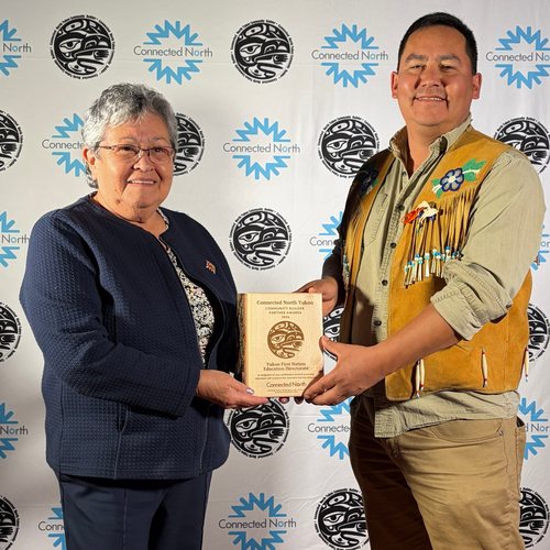 Commissioner Adeline Webber and Chief Sean Uyenets’echᶖa Smith with a Community Builder Partner Award